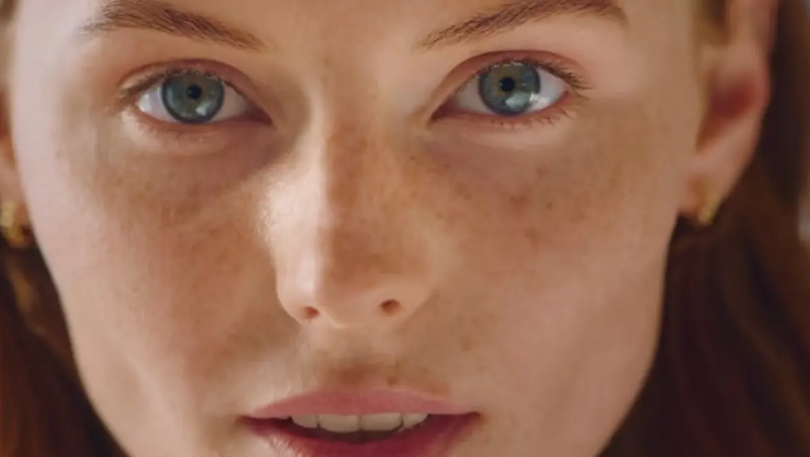 Close-up of a woman's face from the Krups coffee machine ad video