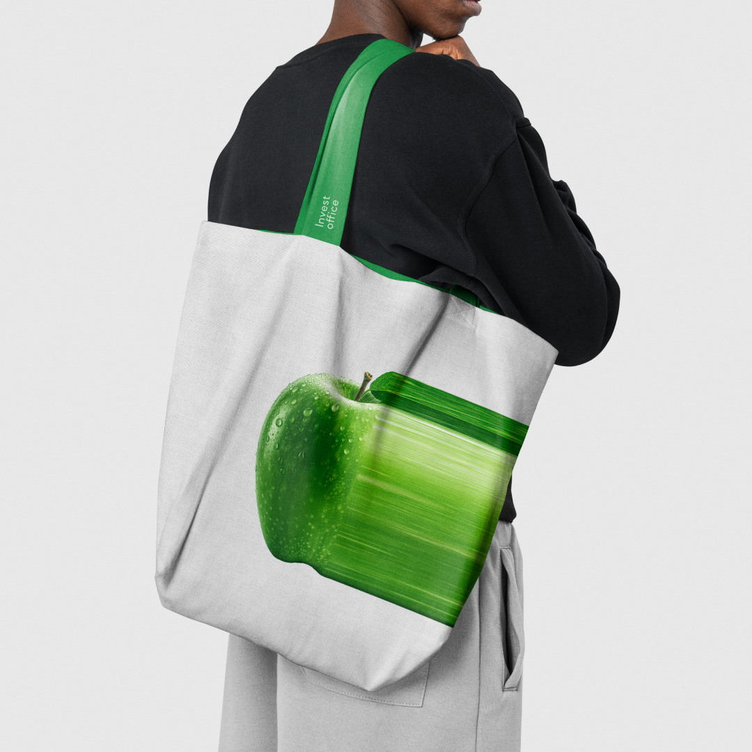 Invest Office tote bag with a green apple printed on it