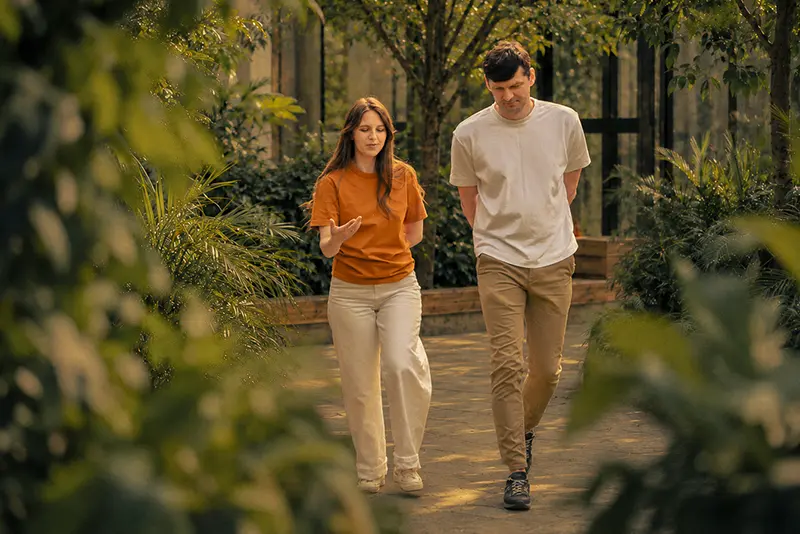 Two Bambuk team members talking on a garden path